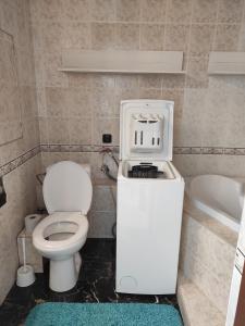 a bathroom with a toilet and a sink and a tub at Apartmán Líška v Tatranskej Štrbe in Tatranska Strba
