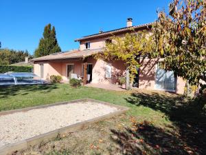 a house with a garden in front of it at Maison d'hôtes Beauregard in Donneville