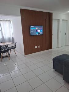 a living room with a tv on a wall at my sweet place 18 in São Luís