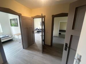 a hallway with two doors and a room with a table at Monteur-Pension W8 in Bad Schmiedeberg