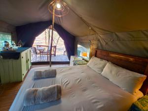 a bedroom with a bed in a tent at Kruger Dreams Lodge in Marloth Park