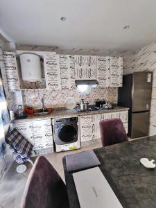 a kitchen with a sink and a stove top oven at Le paradis in Martil