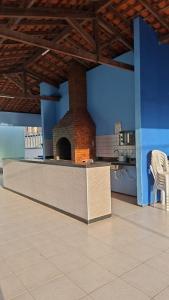 a kitchen with a brick oven in the middle of a room at my sweet place 18 in São Luís