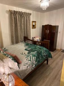 a bedroom with a bed and a dresser in it at Unique folly surrounded by stunning countryside in Kircubbin +11 photos
