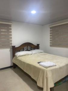 a bedroom with a bed with a blanket on it at La bendición de sunnyvale in La Vega
