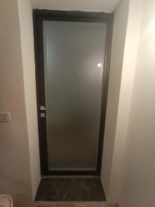 una puerta de cristal en una habitación con una pared en Sidera, en Dervio