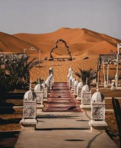 a pathway in the middle of the desert at fabulousluxurycamp in Merzouga