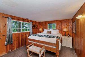 a bedroom with a bed and a chair in it at Emerald Arrowhead Haus - For 6 in Lake Arrowhead
