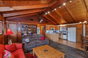 a living room with a couch and a table at Emerald Arrowhead Haus - For 6 in Lake Arrowhead +30 photos