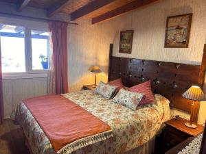 a bedroom with a large bed and a window at TENERIFE ECOLIFE HOUSES by APARTAMENTOS ESTRELLA DEL NORTE in Garachico