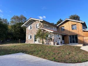a large brick house with a large yard at Ferme Ihartzetako in Ascain