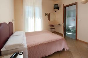 Postel nebo postele na pokoji v ubytování Hotel Souvenir