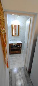 a bathroom with a sink and a mirror at Antar Mouna in Cortaderas