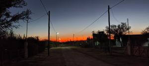a dirt road with a sunset in the background at Antar Mouna in Cortaderas