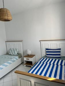 two beds sitting next to each other in a room at Villa Nouryan l'Azur of Carthage in La Marsa