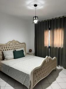 a bedroom with a large bed and a window at Villa Nouryan l'Azur of Carthage in La Marsa