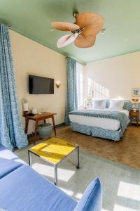 a bedroom with two beds and a ceiling fan at Hôtel Amista Marseille - ancien Hôtel Saint Louis - Vieux Port in Marseille