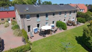 an overhead view of a large brick building with an umbrella at Bauernhof Claussen Fehmarn in Fehmarn