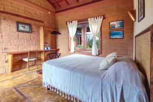 a bedroom with a bed and a desk and a window at Hotel Casa San Pancho in San Francisco