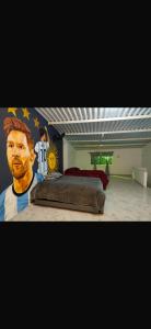 a bedroom with a bed with a football player on it at Apartamento amoblado in Los Santos