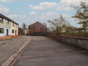 an empty street with a brick building in the background at Valley View in Cleator Moor