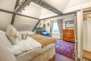 a bedroom with a large bed and a dresser at Stylish Lewes Apartment - Gorgeous Views in Lewes