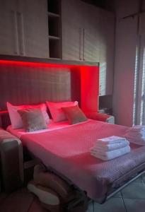 a large bed with red lights on top of it at Reba House with Terrace in Turin