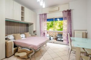 a bedroom with a bed and a desk and a window at Reba House with Terrace in Turin