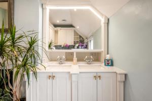 a bathroom with a sink and a mirror at Stylish Lewes Apartment - Gorgeous Views in Lewes +31 photos