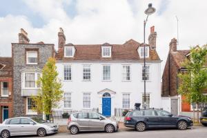 a white house with cars parked in front of it at Stylish Lewes Apartment - Gorgeous Views in Lewes