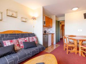 a living room with a couch and a table and a kitchen at Studio 4 pers à Avoriaz, au calme avec balcon - FR-1-314-314 in Avoriaz