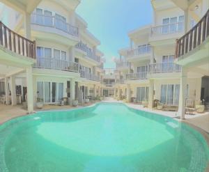 a large swimming pool in the middle of a building at Hotel Blue Note in Hikkaduwa