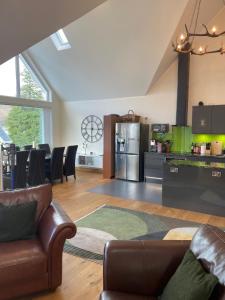 a kitchen and living room with a couch and a refrigerator at The Owlery in Fort William