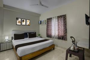 Ένα ή περισσότερα κρεβάτια σε δωμάτιο στο Hotel O New Marine Drive Puri Formerly Padmahar