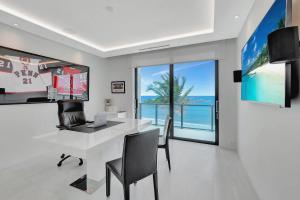 an office with a white desk and a view of the ocean at Oceanfront Four-Bedroom Luxury Villa in Boca Harbour +25 photos