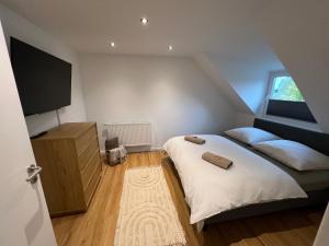 a bedroom with two beds and a flat screen tv at Zentral gelegen in Haan - 4 Schlafzimmer- Bis zu 7 Personen in Haan