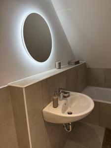 a bathroom with a sink and a mirror at Zentral gelegen in Haan - 4 Schlafzimmer- Bis zu 7 Personen in Haan