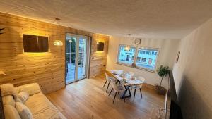 een woonkamer met een tafel en een bank bij TheWoodenStack in Waldachtal