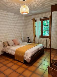 a bedroom with a large bed in a room at Casa rural La Plana in Alcover
