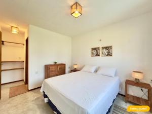 a bedroom with a large white bed in a room at Reserva Retirinho B in Aracati +25 photos