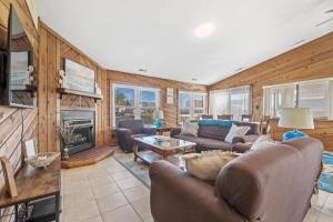 a living room with a couch and a fireplace at Star of the Sea in Virginia Beach