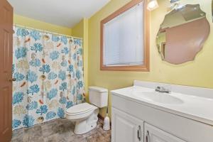 a bathroom with a toilet and a sink and a mirror at Star of the Sea in Virginia Beach +40 photos