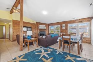 a living room with a couch and a table at Star of the Sea in Virginia Beach
