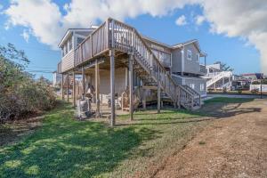 a house with a wooden staircase leading up to it at Star of the Sea in Virginia Beach