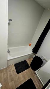 a bathroom with a white bath tub in a room at City home de lens in Lens