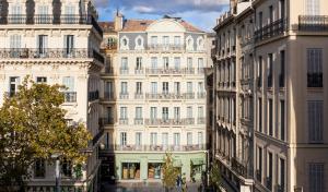 a group of buildings in a city at Hôtel Amista Marseille - ancien Hôtel Saint Louis - Vieux Port in Marseille
