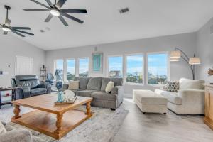 a living room with a couch and a table at Bella Vista by Gulf Coast Getaways in Pensacola Beach