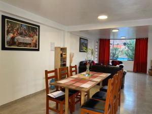 a living room with a table and chairs and a couch at Adriano's Deluxe Apartments 1 in Cusco