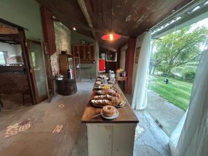 a long table in a room with food on it at Pousada Charqueada Costa do Abolengo in Pelotas