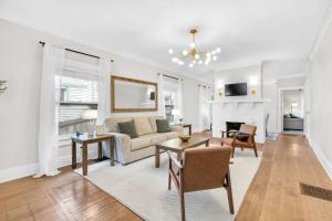 a living room with a couch and a table at MidTown Cozy Cottage in Indianapolis